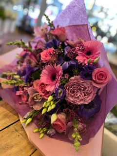 Pink roses, Gerber daisies, purple anemones, lisianthus and cymbidium orchid heads  garden bouquet – Jerome Florists NYC