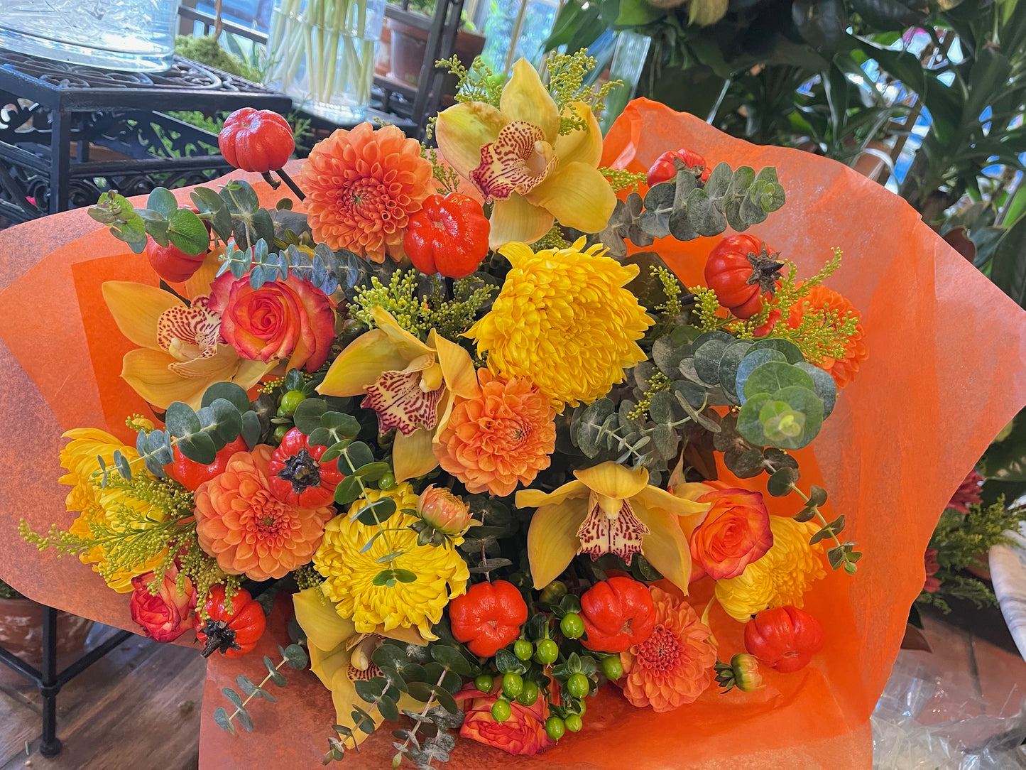 
                    
                      Orange rose, dahlia, cymbidium orchid heads, ruscus and calla lily autumn bouquet – Jerome Florists NYC
                    
                  