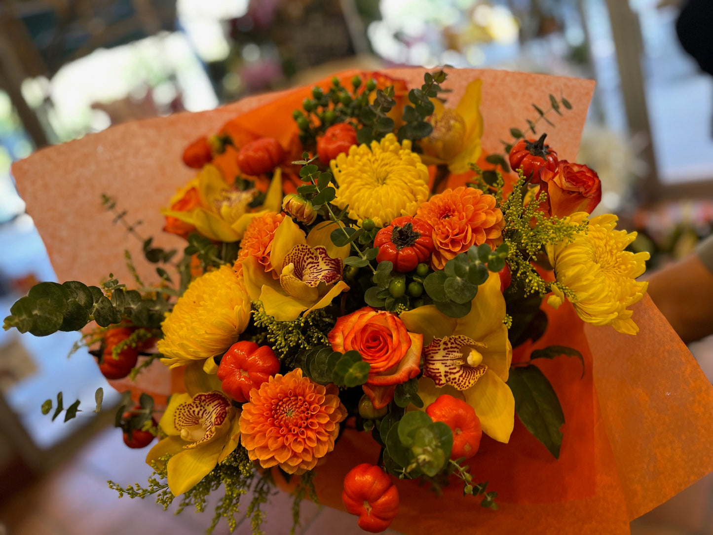 
                    
                      Orange rose, dahlia, cymbidium orchid heads, ruscus and calla lily autumn bouquet – Jerome Florists NYC
                    
                  