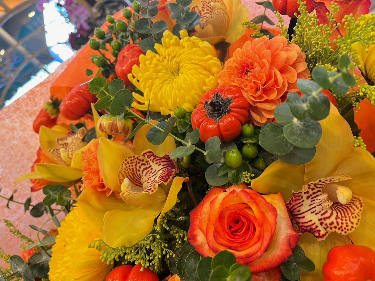 
                    
                      Orange rose, dahlia, cymbidium orchid heads, ruscus and calla lily autumn bouquet – Jerome Florists NYC
                    
                  