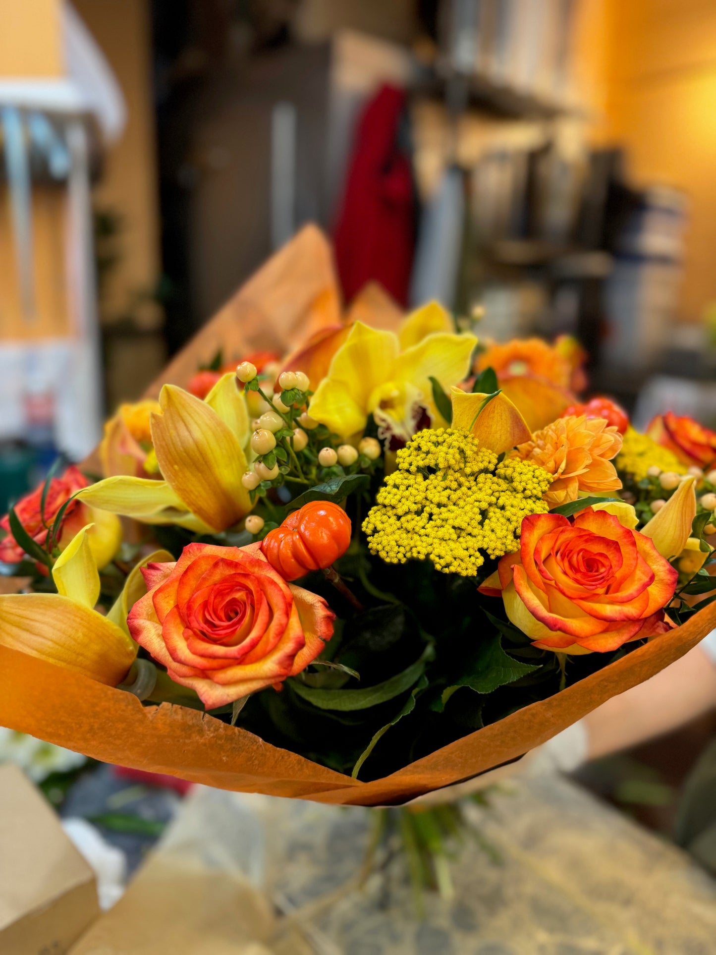 Orange rose, dahlia, cymbidium orchid heads, ruscus and calla lily autumn bouquet – Jerome Florists NYC