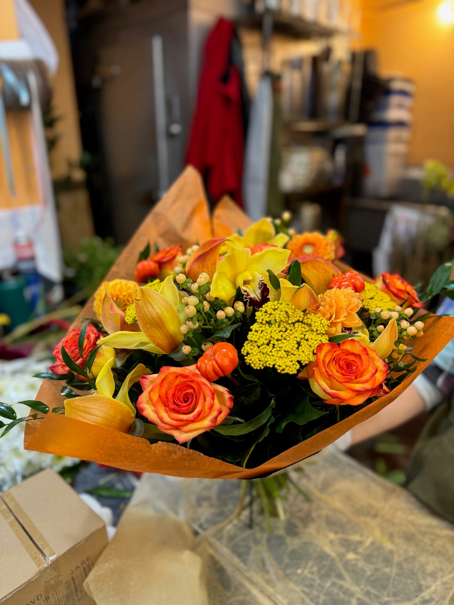 
                    
                      Orange rose, dahlia, cymbidium orchid heads, ruscus and calla lily autumn bouquet – Jerome Florists NYC
                    
                  